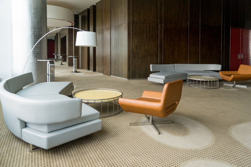 Modern luxury hotel lobby featuring dynamic workspace design, contemporary reception area, and lounge seating